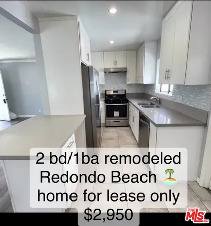 a kitchen with a stove a refrigerator a sink and a stove