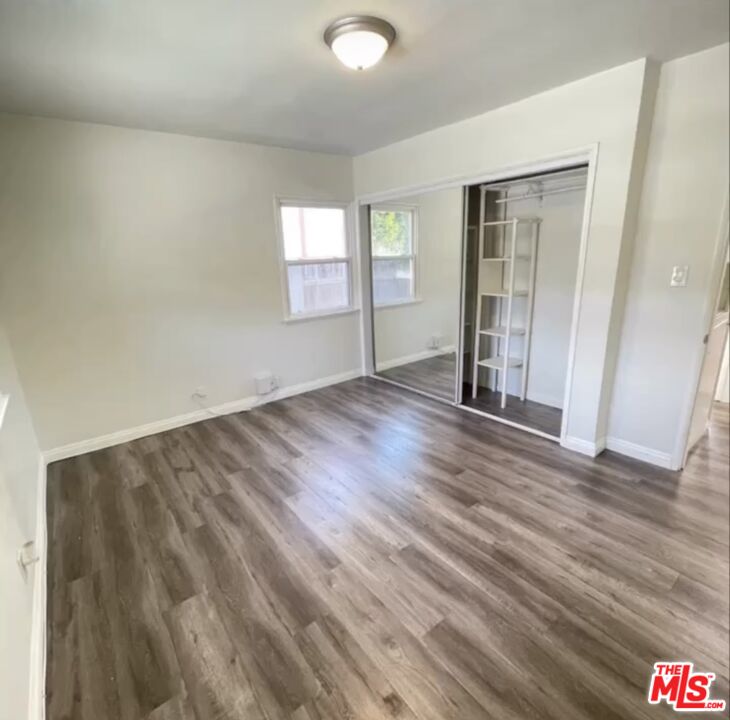 2607 Rockefeller Lane, Unit 1 Redondo Beach, CA 90278 - Photo 3 of 11 an empty room with wooden floor and windows