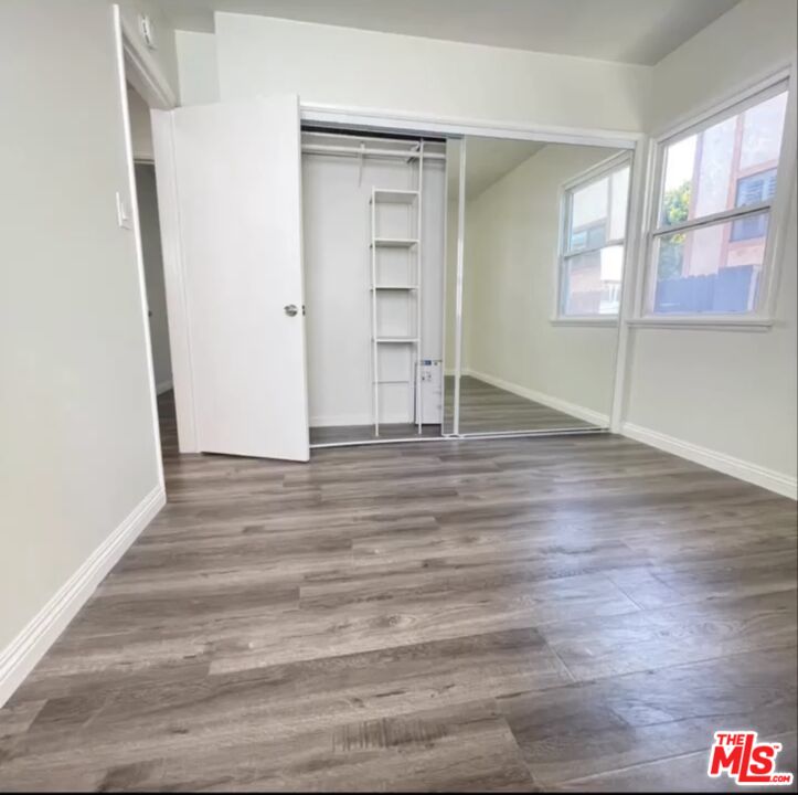 2607 Rockefeller Lane, Unit 1 Redondo Beach, CA 90278 - Photo 7 of 11 an empty room with wooden floor and windows