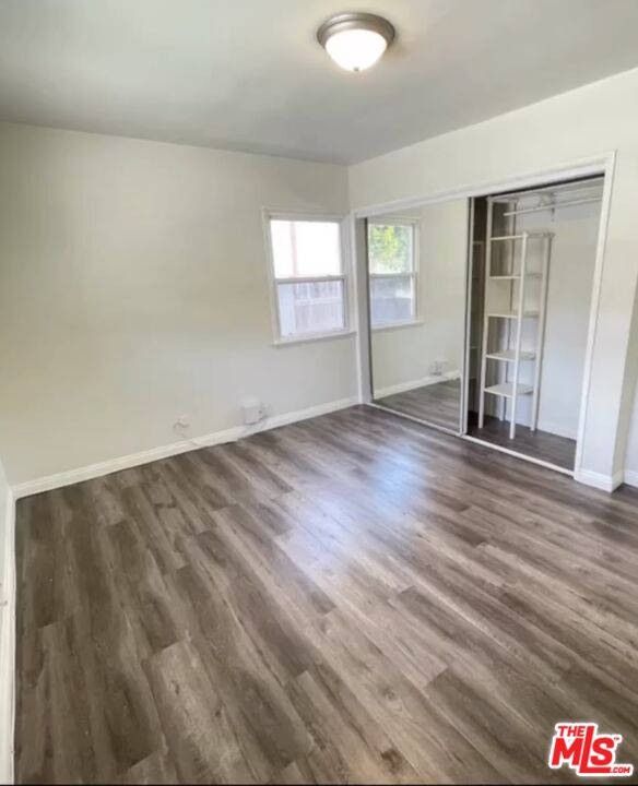 2607 Rockefeller Lane, Unit 1 Redondo Beach, CA 90278 - Photo 8 of 11 an empty room with wooden floor and windows