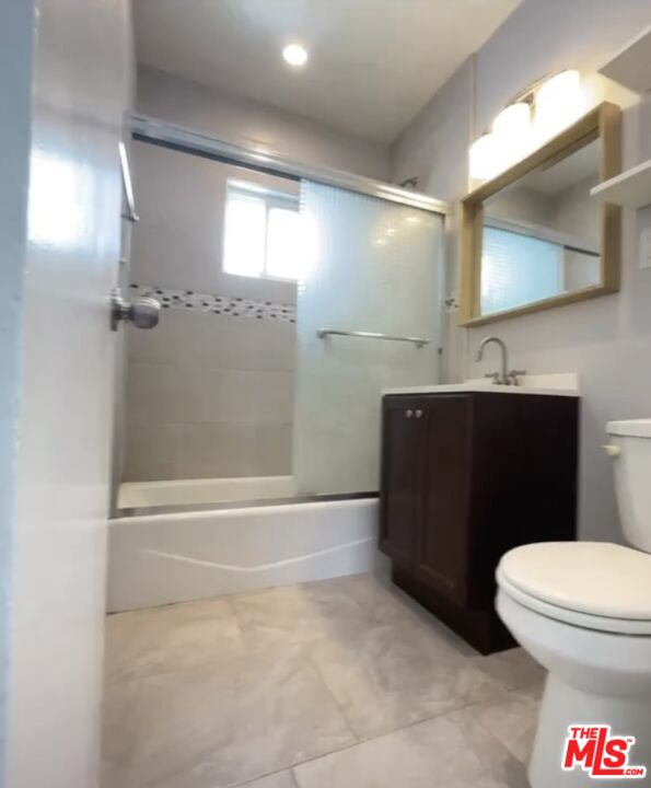 2607 Rockefeller Lane, Unit 1 Redondo Beach, CA 90278 - Photo 9 of 11 a bathroom with a sink a toilet and mirror