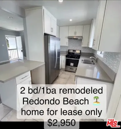 a kitchen with a stove a refrigerator and a sink