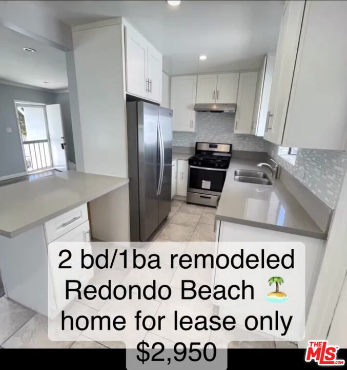 2607 Rockefeller Lane, Unit 1 Redondo Beach, CA 90278 - Photo 10 of 11 a kitchen with a stove a refrigerator and a sink