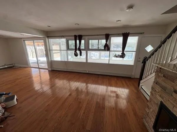 wooden floor in an empty room with a window