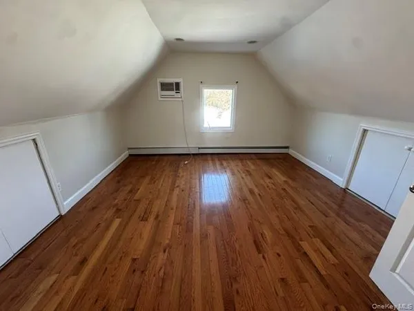 a view of a room with wooden floors and window