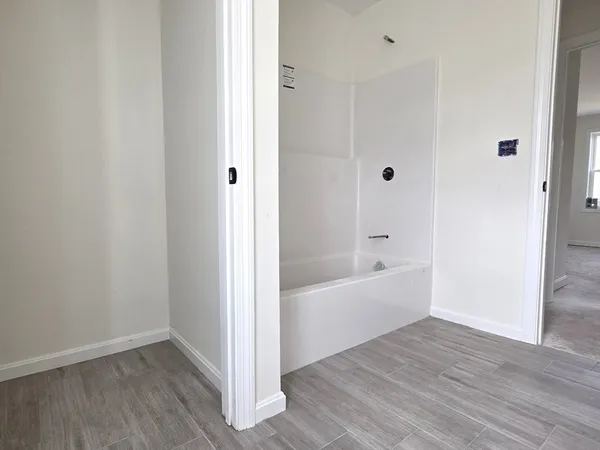 a bathroom with a bathtub and shower