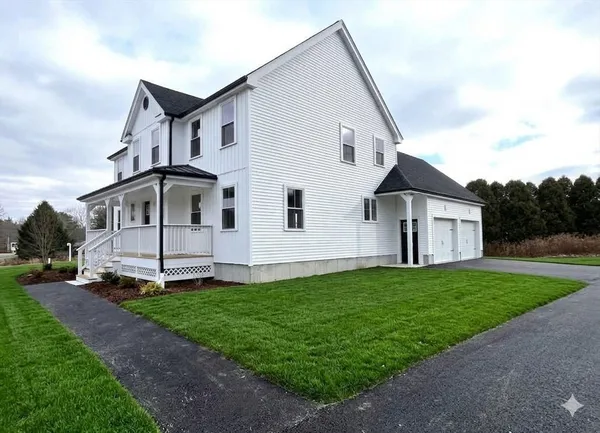 a view of a white house with a yard