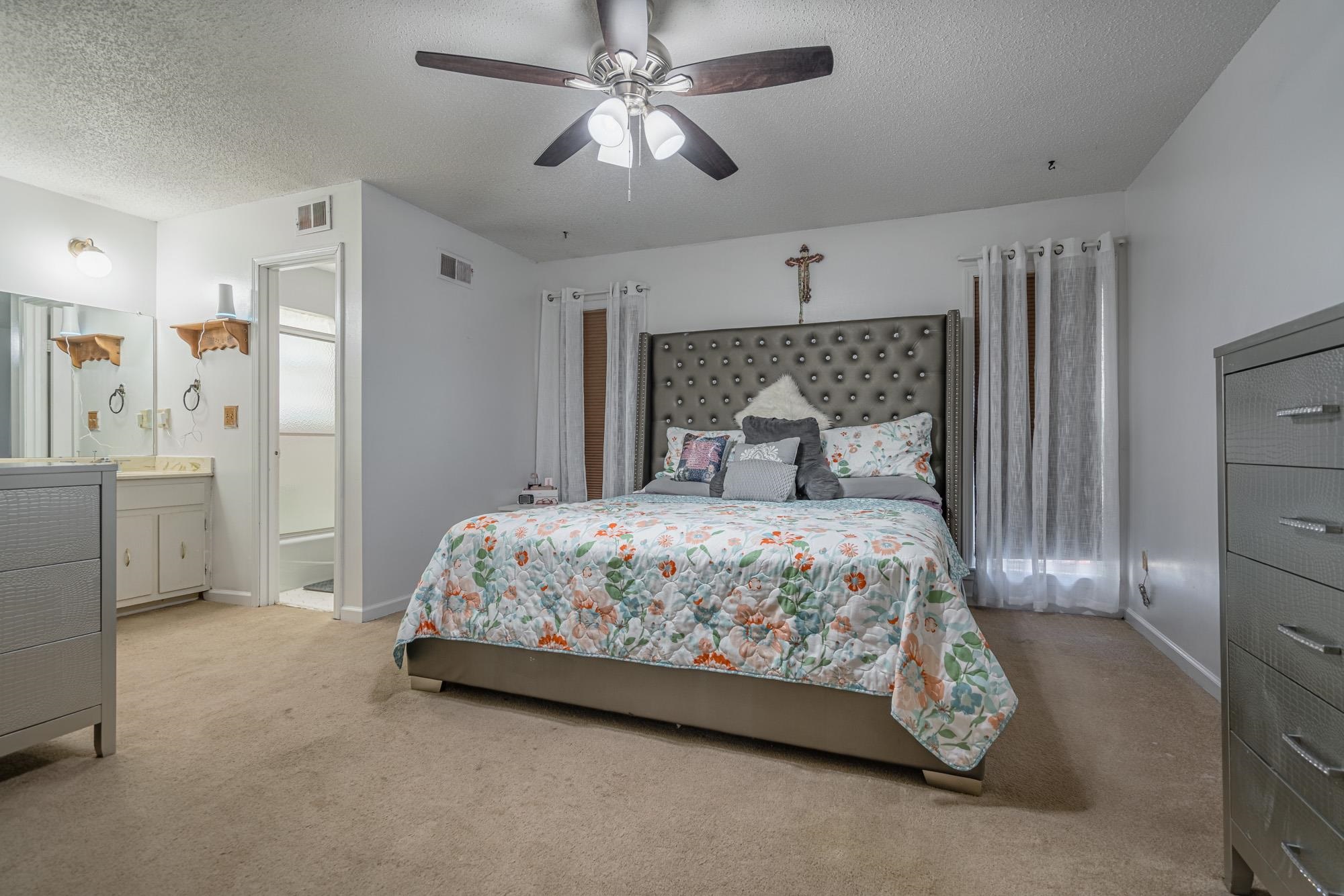 5640 Rensslaer Drive Memphis, TN 38135 - Photo 16 of 29 a bedroom with a large bed and a chandelier