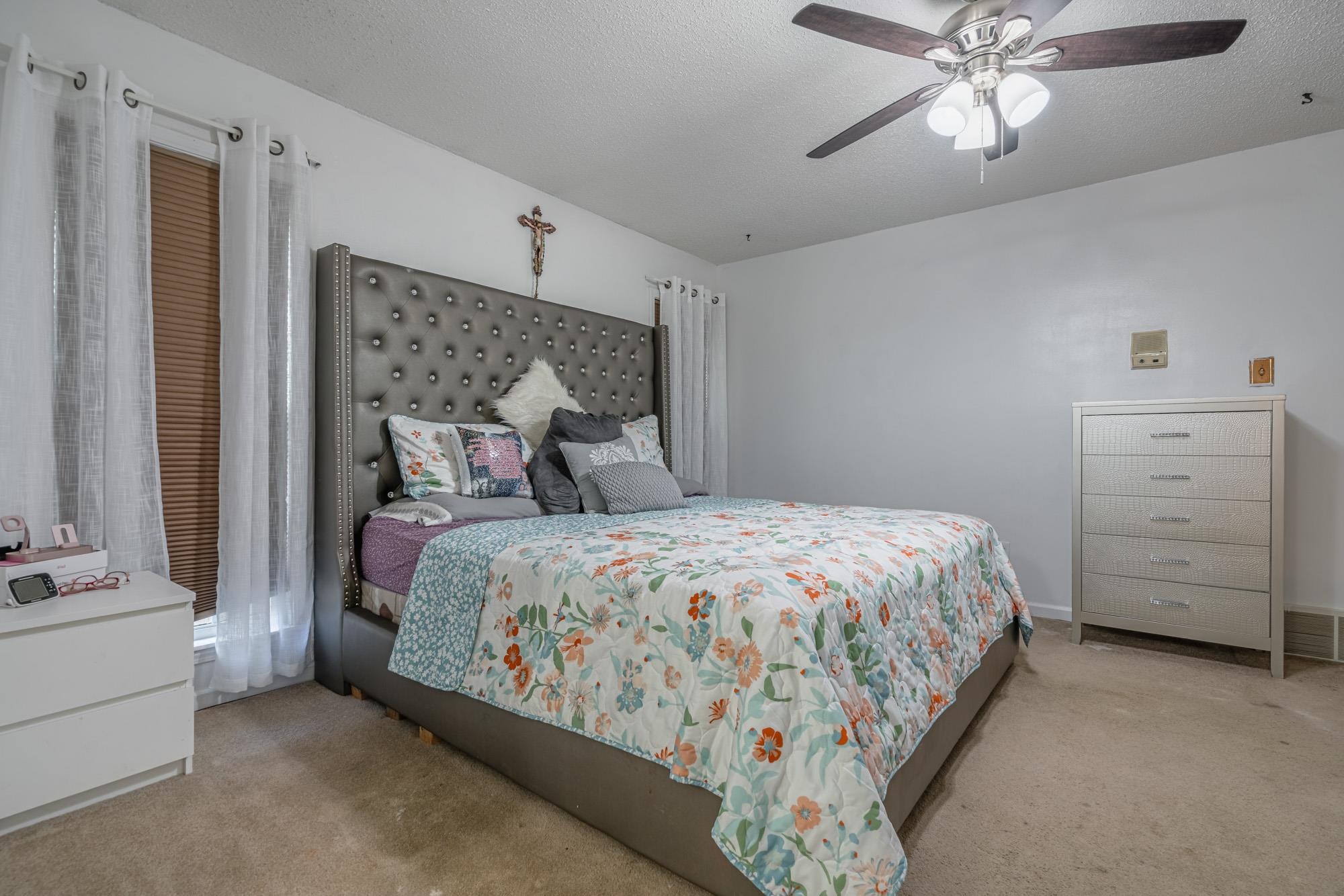 5640 Rensslaer Drive Memphis, TN 38135 - Photo 17 of 29 a bedroom with a bed and a chandelier
