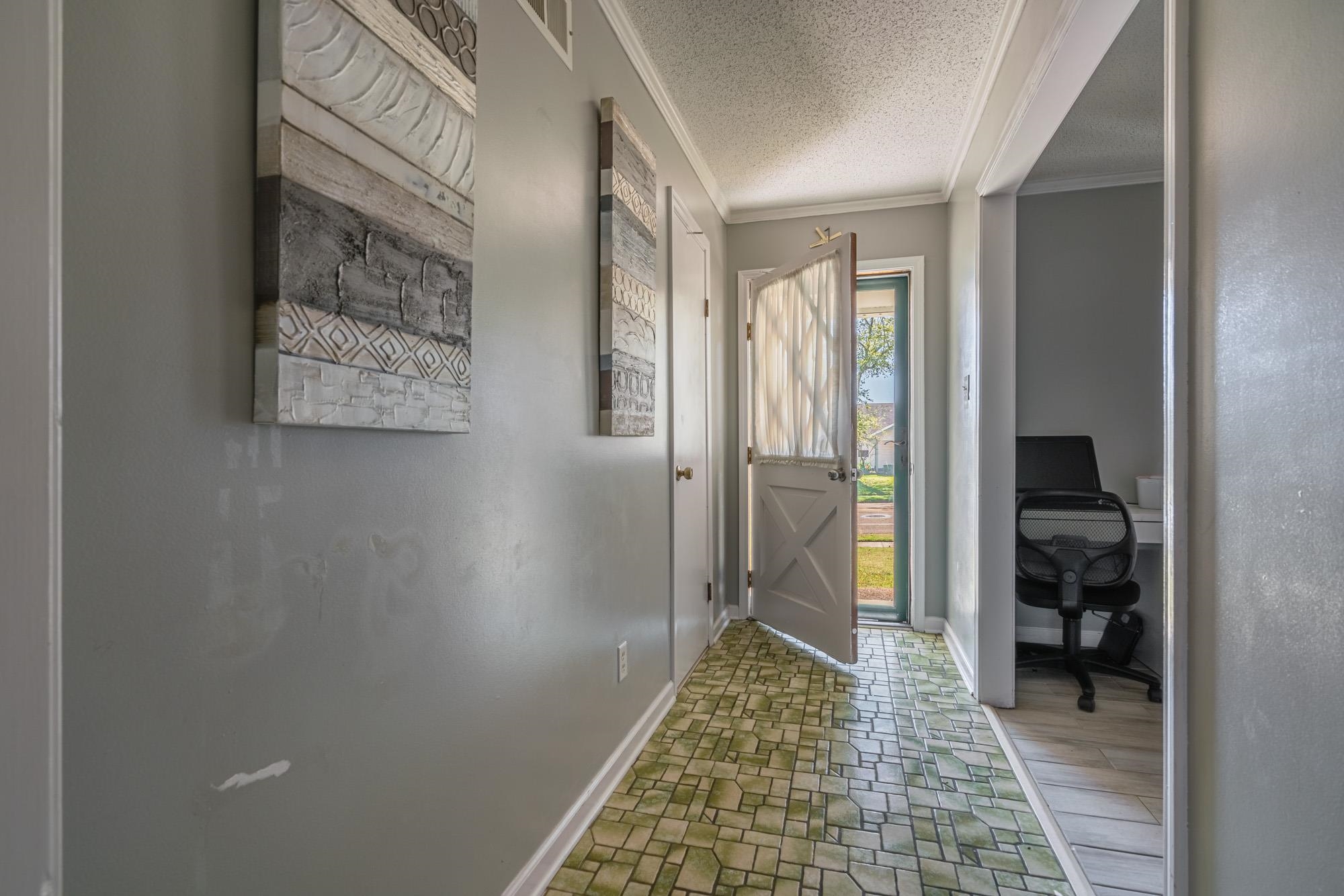 5640 Rensslaer Drive Memphis, TN 38135 - Photo 5 of 29 a hallway with a closet and a couch