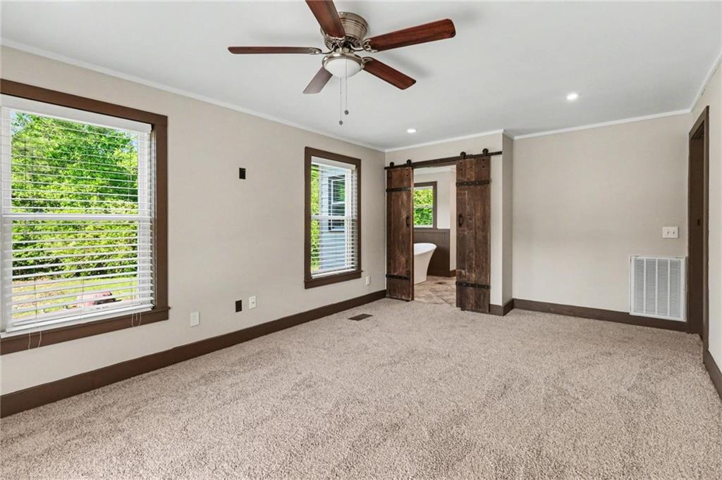 450 Big Springs Road Southeast Calhoun, GA 30701 - Photo 15 of 39 a view of an empty room with a window and a ceiling fan