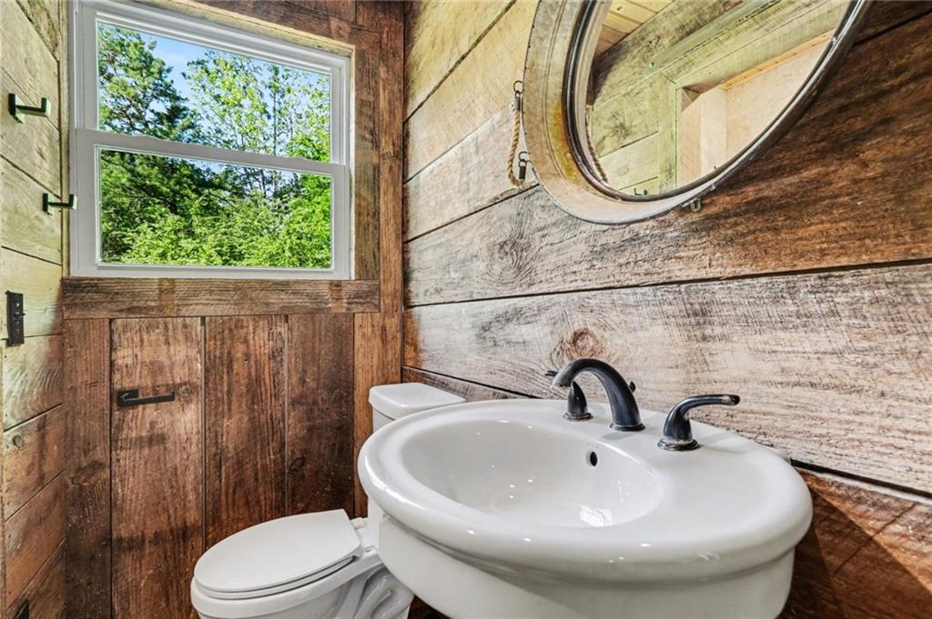 450 Big Springs Road Southeast Calhoun, GA 30701 - Photo 25 of 39 a bathroom with a sink a toilet and a mirror