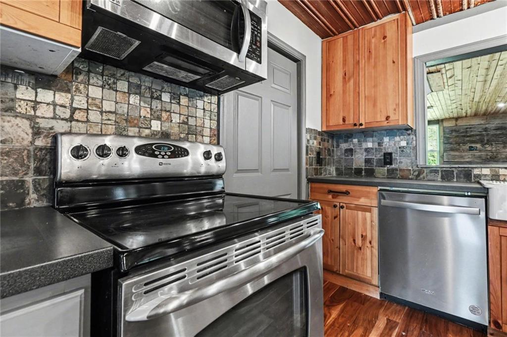 450 Big Springs Road Southeast Calhoun, GA 30701 - Photo 10 of 39 a kitchen with a stove and a microwave