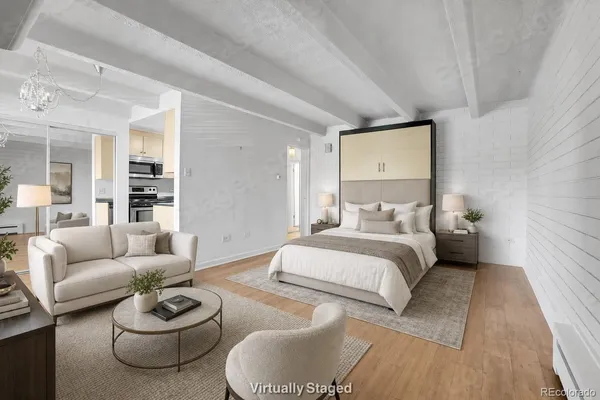 a spacious bedroom with a bed and a couch