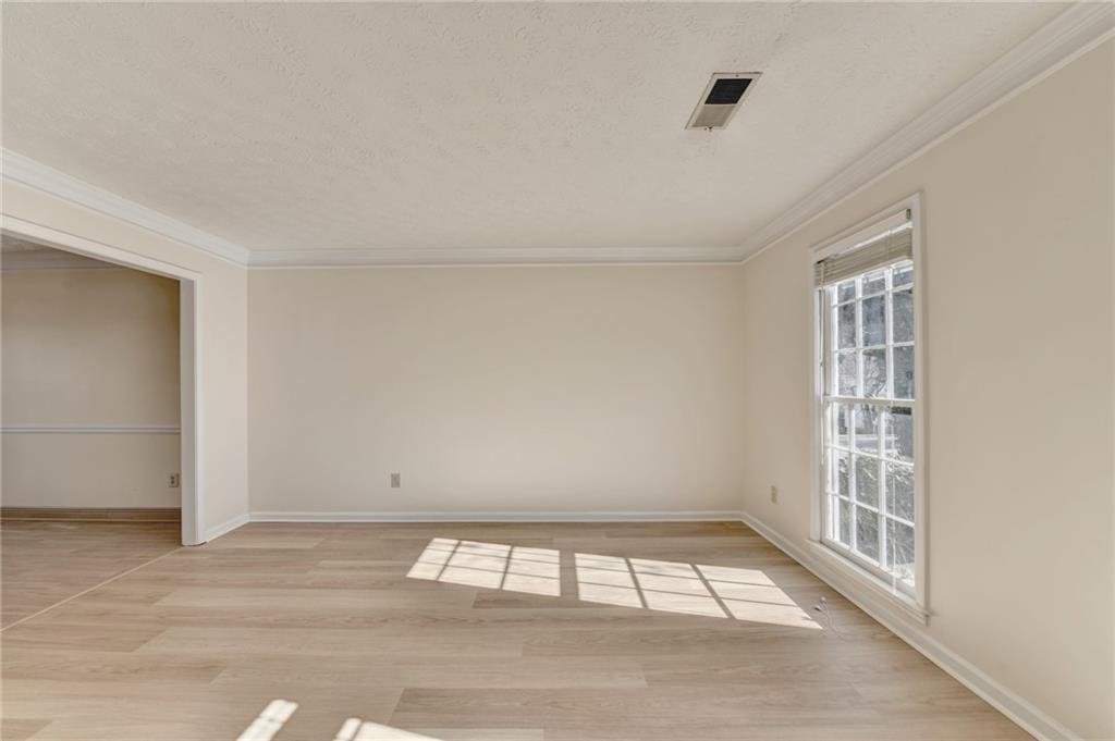 3945 Genoa Court Duluth, GA 30096 - Photo 11 of 64 a view of an empty room with wooden floor and a window