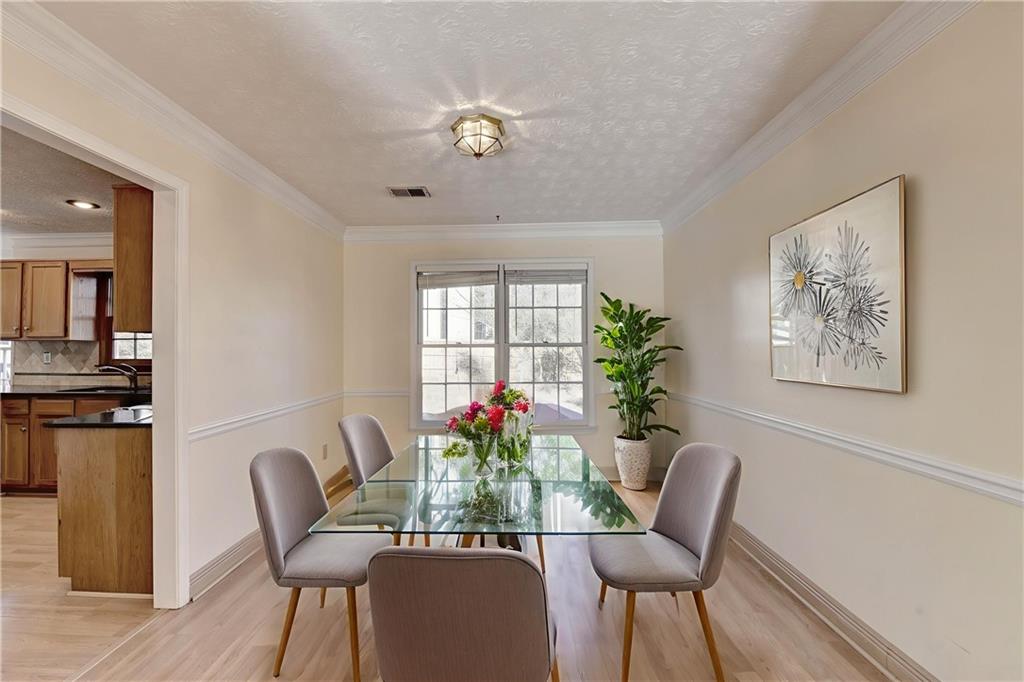 3945 Genoa Court Duluth, GA 30096 - Photo 13 of 64 a view of a dining room with furniture window and wooden floor