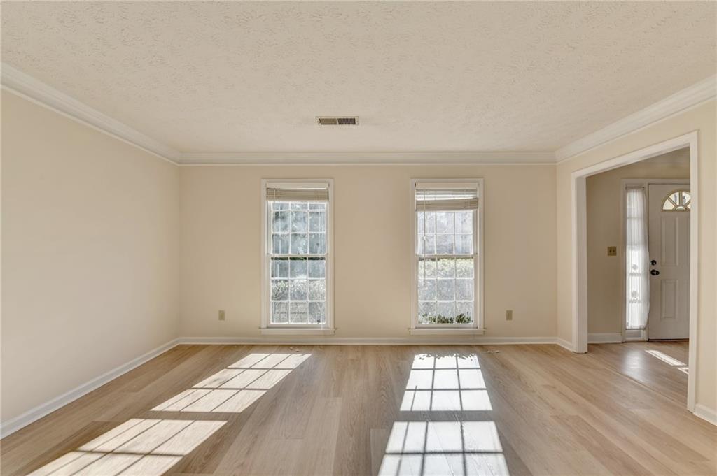 3945 Genoa Court Duluth, GA 30096 - Photo 14 of 64 an empty room with wooden floor and windows