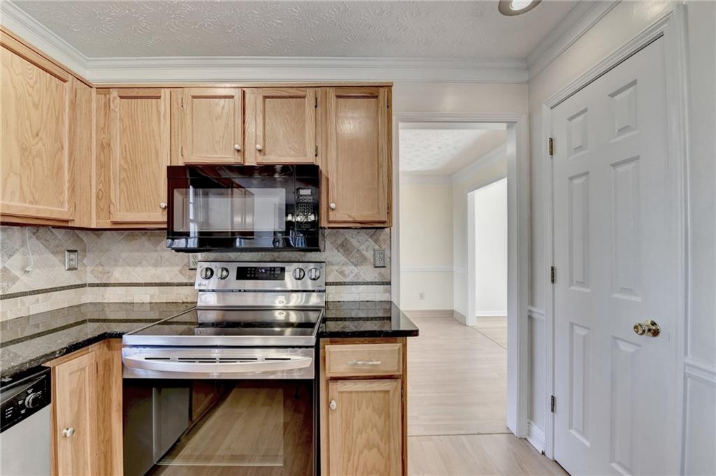 3945 Genoa Court Duluth, GA 30096 - Photo 24 of 64 a kitchen with a stove and a microwave