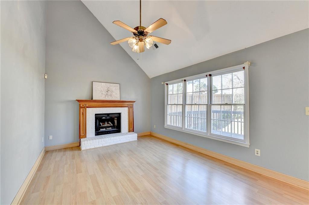 3945 Genoa Court Duluth, GA 30096 - Photo 33 of 64 wooden floor fireplace and windows in an empty room