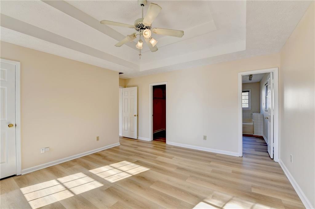 3945 Genoa Court Duluth, GA 30096 - Photo 47 of 64 a view of an empty room with wooden floor and a chandelier