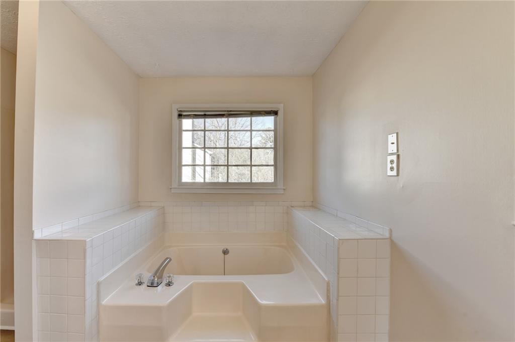 3945 Genoa Court Duluth, GA 30096 - Photo 50 of 64 a bathroom with a bathtub sink and mirror