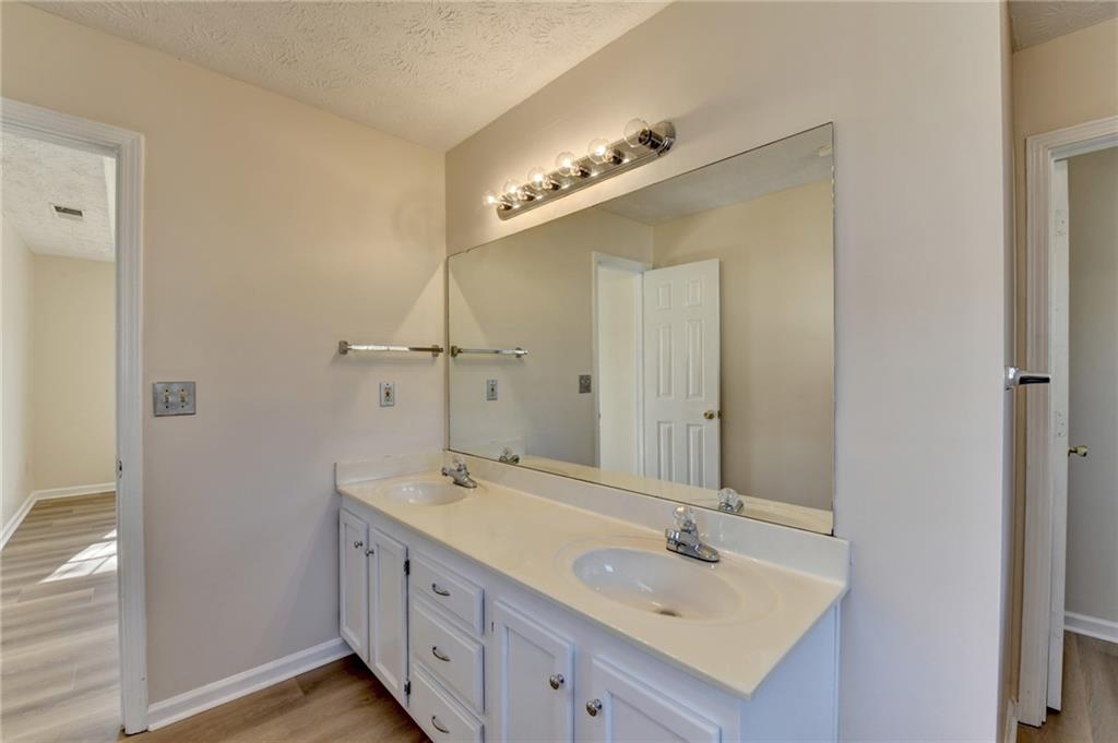 3945 Genoa Court Duluth, GA 30096 - Photo 51 of 64 a bathroom with a double vanity sink and a mirror