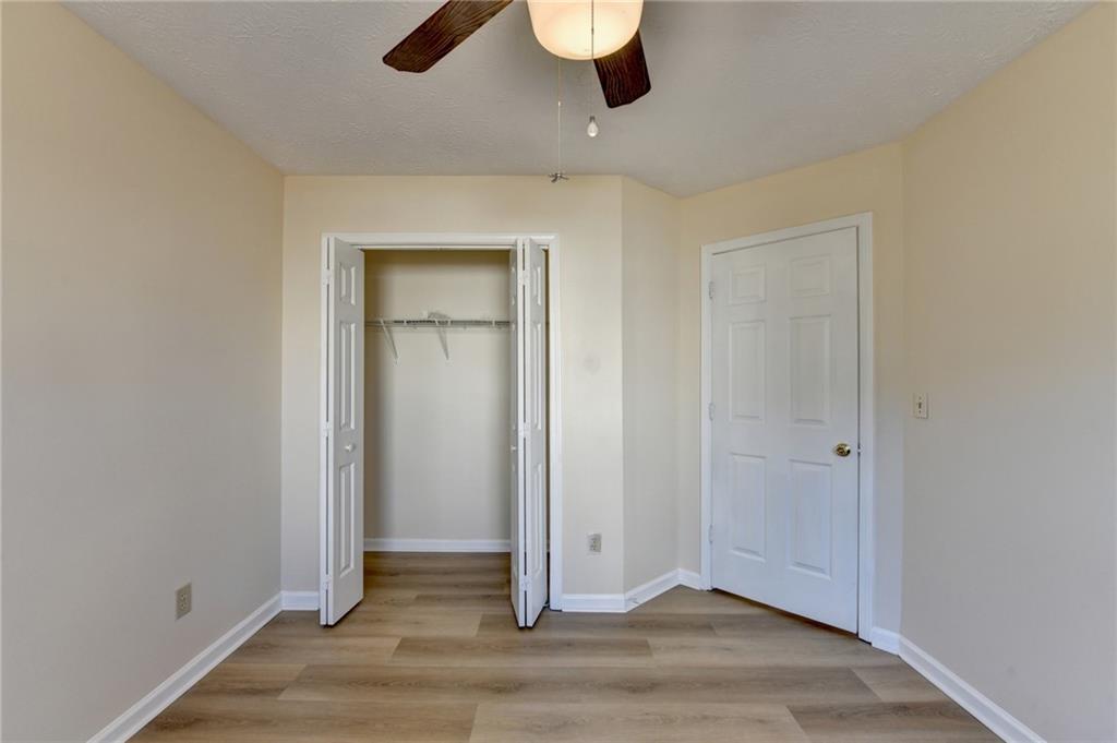 3945 Genoa Court Duluth, GA 30096 - Photo 56 of 64 an empty room with wooden floor and windows