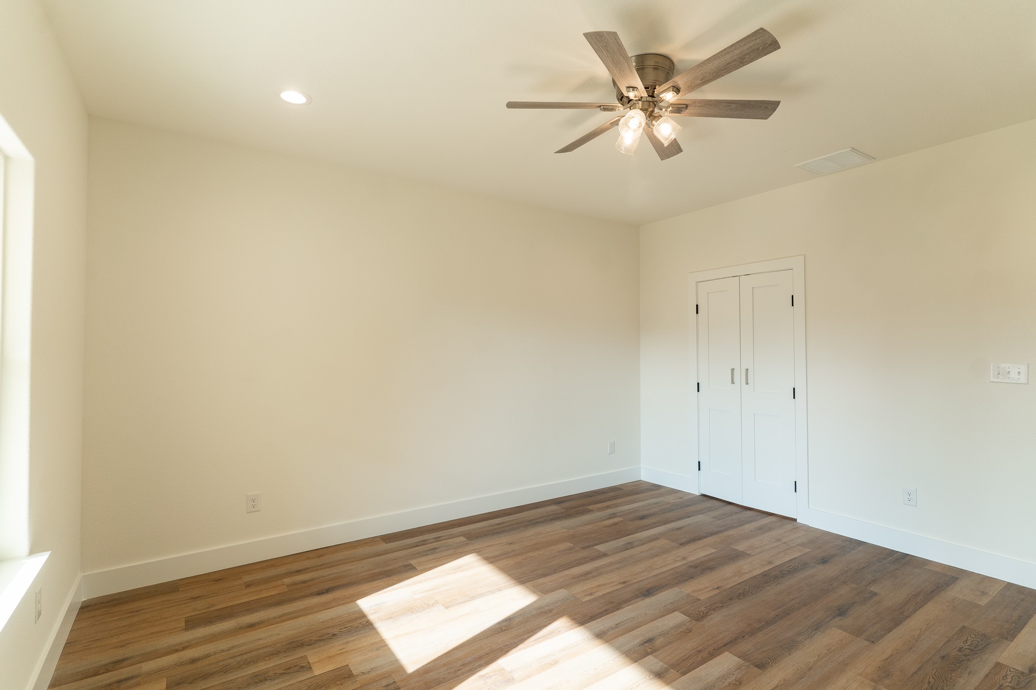 309 String Prairie Way Smithville, TX 78957 - Photo 14 of 30 an empty room with wooden floor and fan