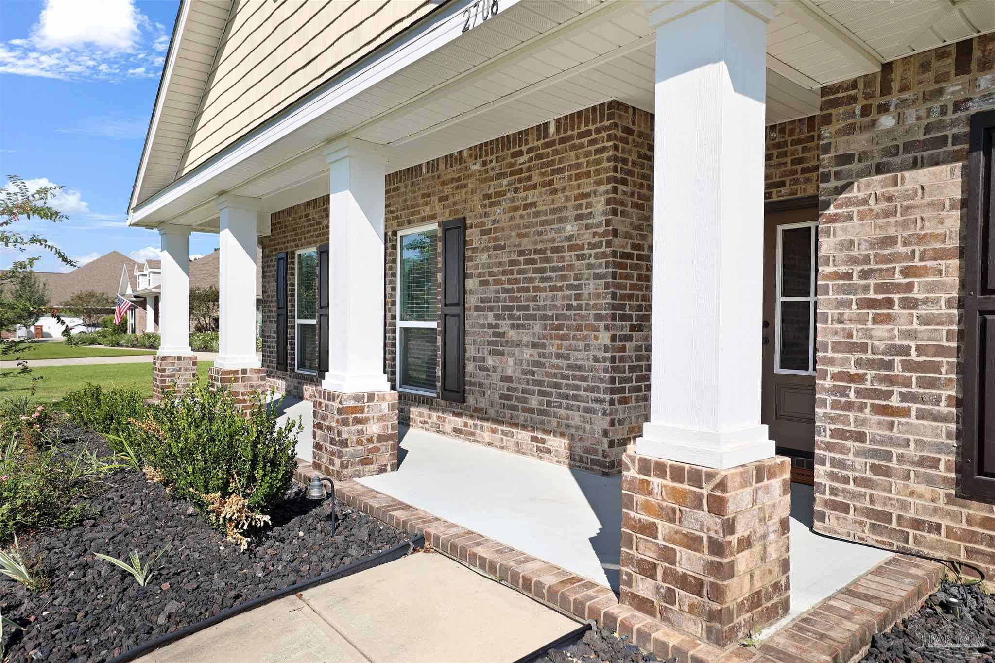 2708 Gemstone Circle Pace, FL 32571 - Photo 2 of 38 a front view of a house with outdoor space