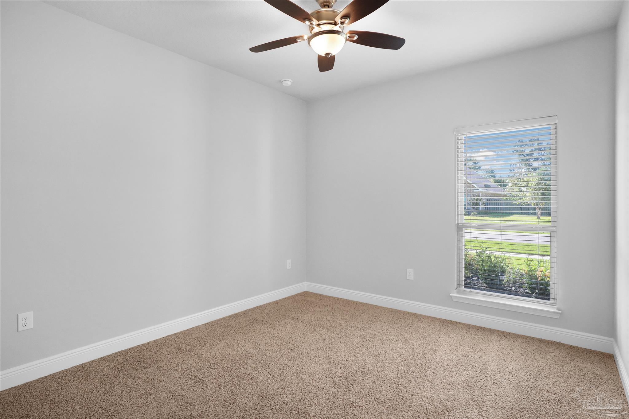 2708 Gemstone Circle Pace, FL 32571 - Photo 21 of 38 an empty room with a window and ceiling fan