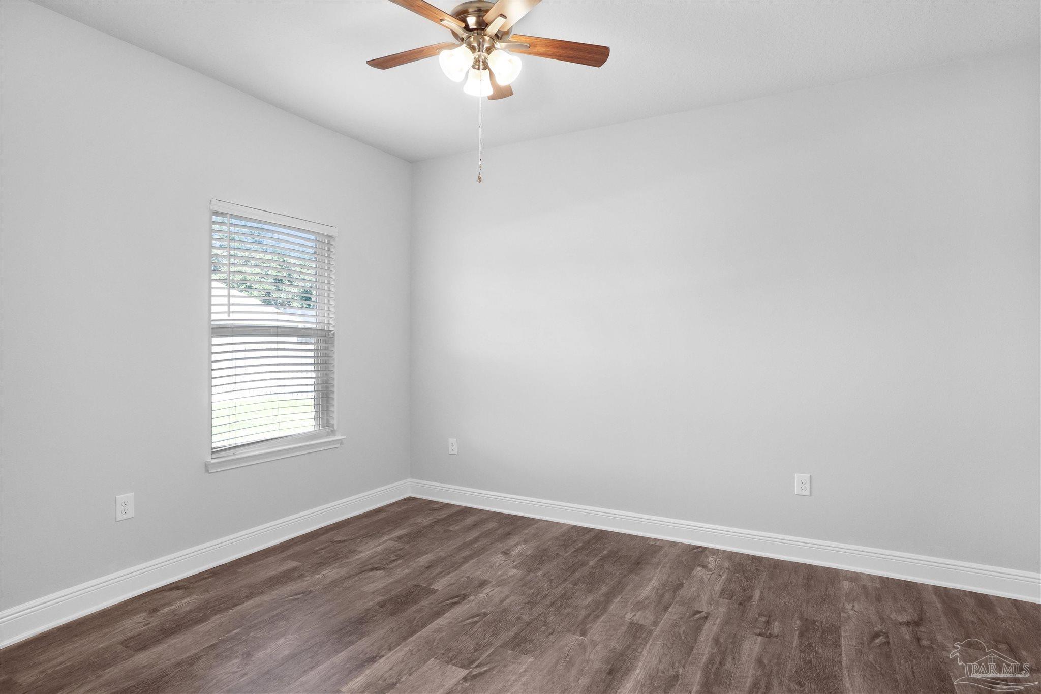 2708 Gemstone Circle Pace, FL 32571 - Photo 23 of 38 an empty room with wooden floor and windows