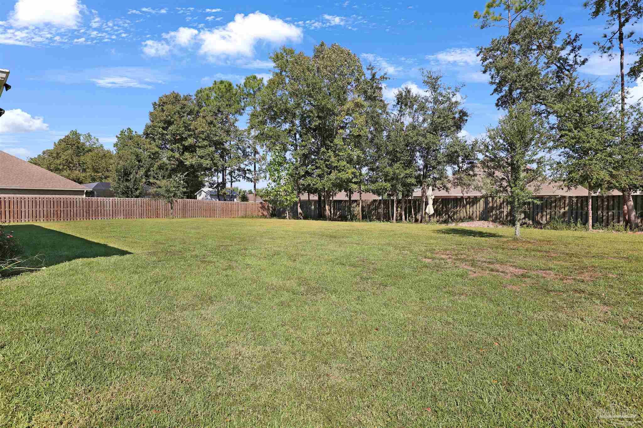 2708 Gemstone Circle Pace, FL 32571 - Photo 30 of 38 a view of a field with trees in the background