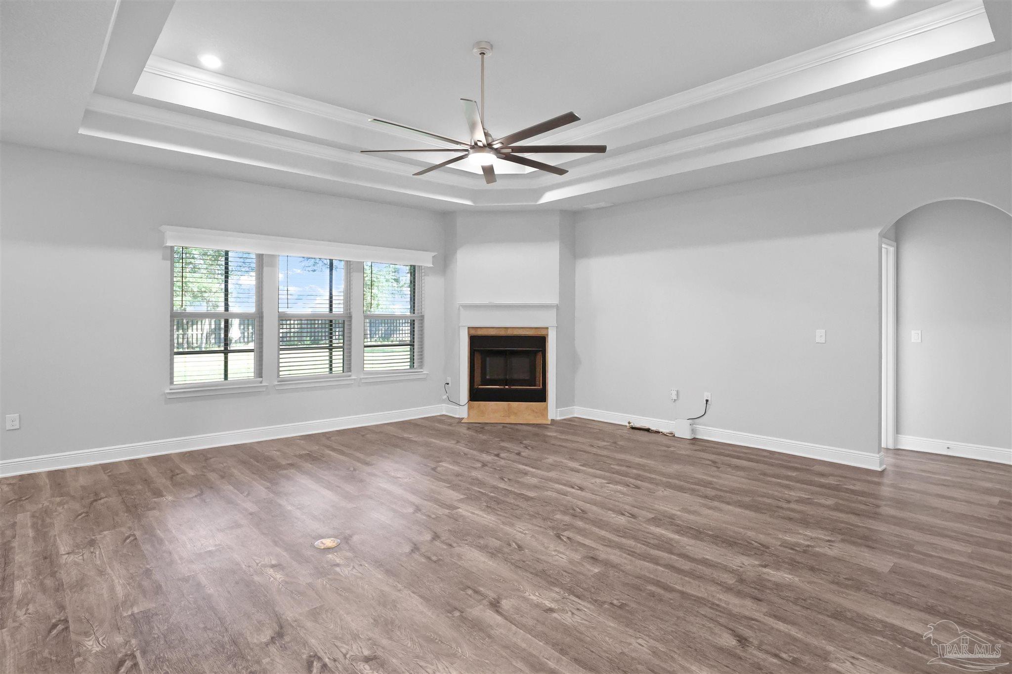 2708 Gemstone Circle Pace, FL 32571 - Photo 6 of 38 a view of an empty room with window and wooden floor