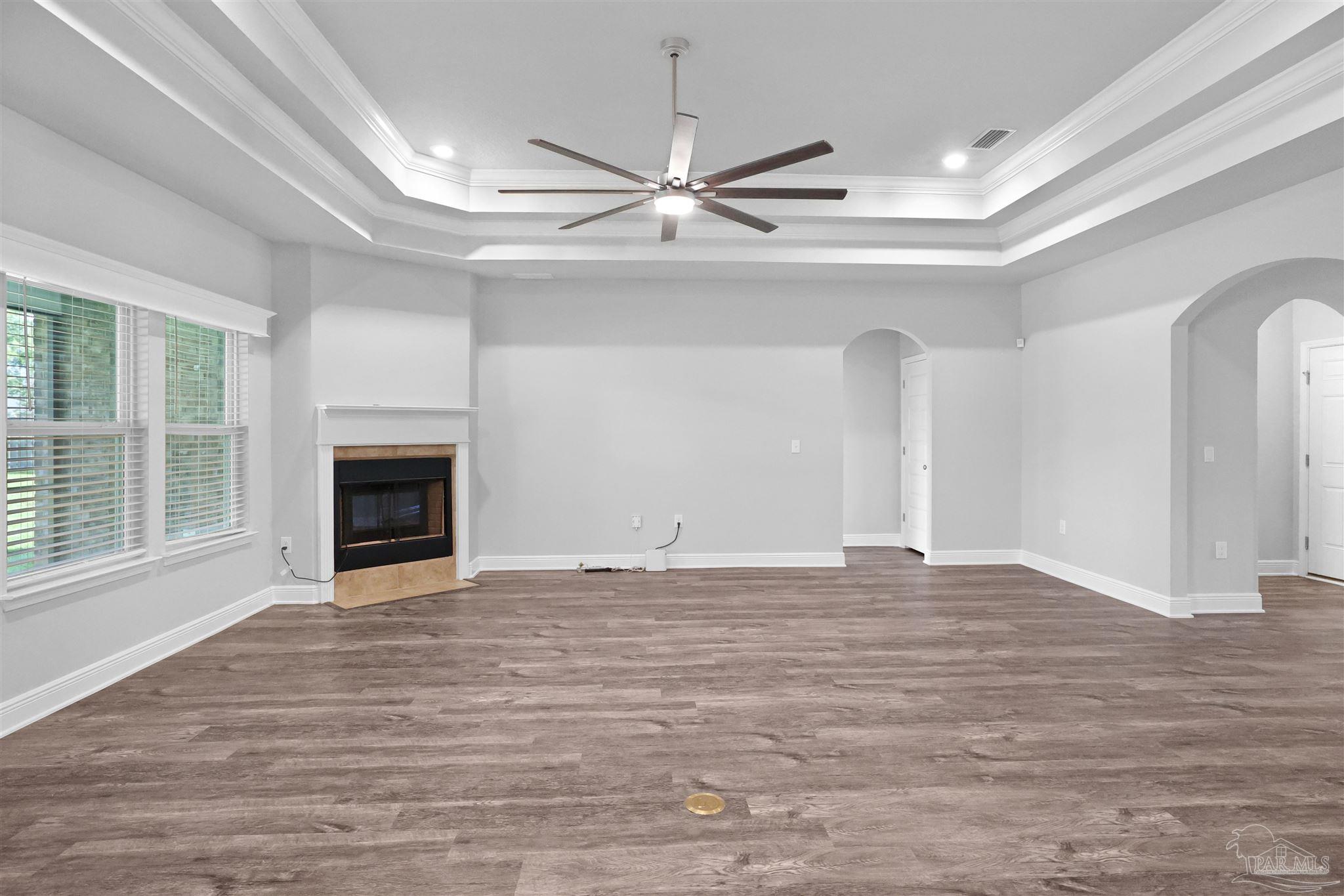 2708 Gemstone Circle Pace, FL 32571 - Photo 7 of 38 a view of empty room with wooden floor and fireplace
