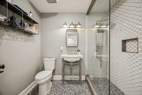 a bathroom with a toilet and a shower