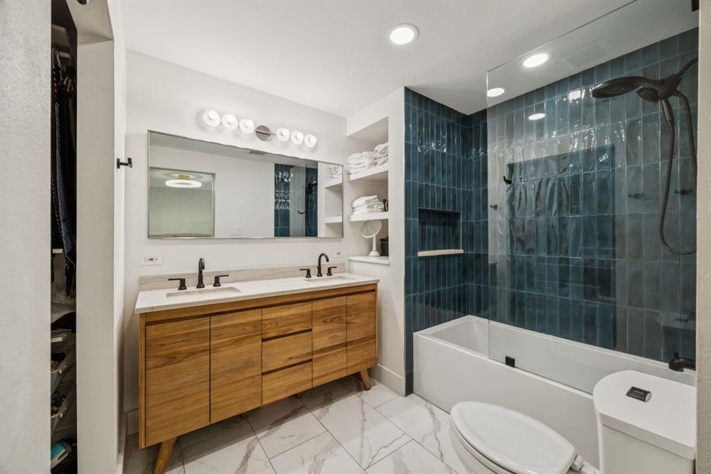 1227 Lansford Avenue Dallas, TX 75224 - Photo 2 of 17 a bathroom with a bathtub shower sink vanity mirror and toilet