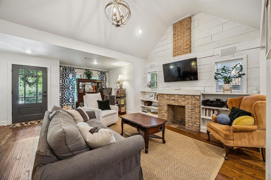 1227 Lansford Avenue Dallas, TX 75224 - Photo 4 of 17 a living room with furniture a fireplace and a flat screen tv