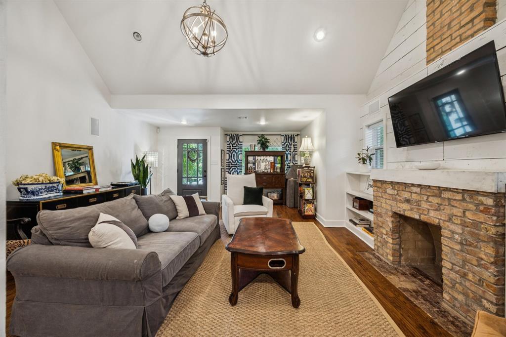 1227 Lansford Avenue Dallas, TX 75224 - Photo 5 of 17 a living room with furniture a flat screen tv and a fireplace