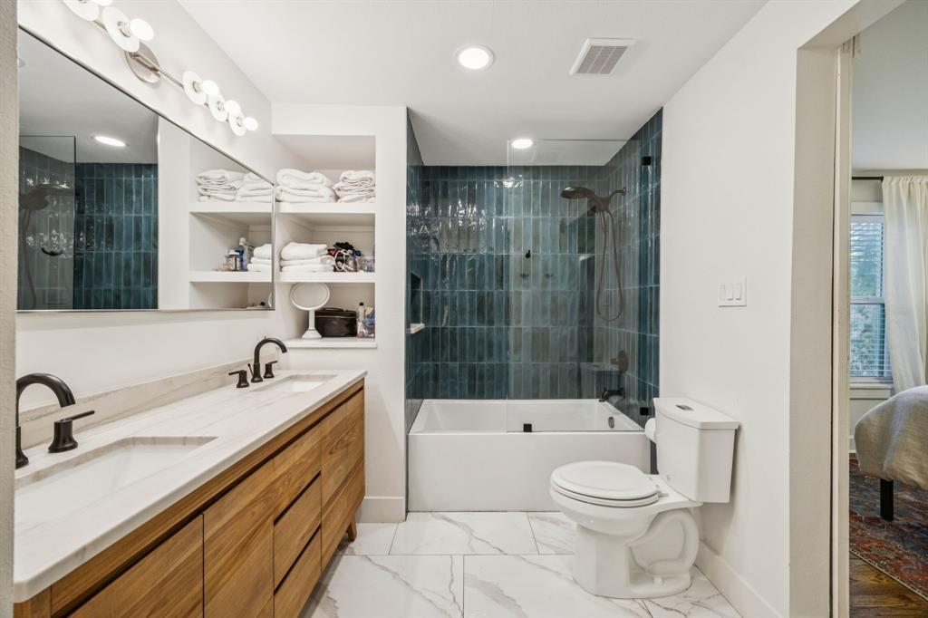 1227 Lansford Avenue Dallas, TX 75224 - Photo 10 of 17 a bathroom with a sink a toilet and shower