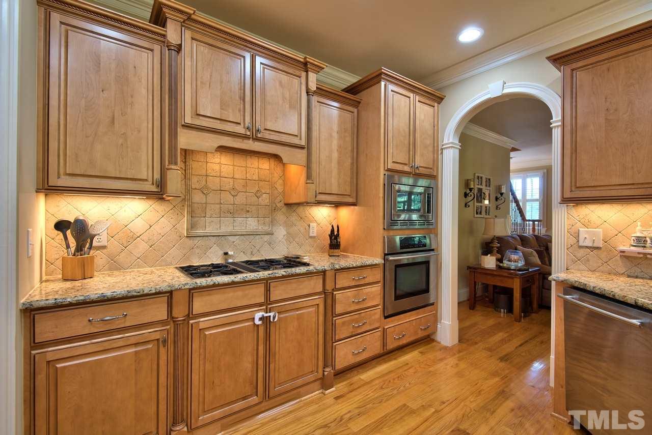 1 Springtree Circle Durham, NC 27712 - Photo 11 of 25 The kitchen features granite counters, tile backsplash, gas cook top with down draft vent, under cabinet lighting and a pantry!