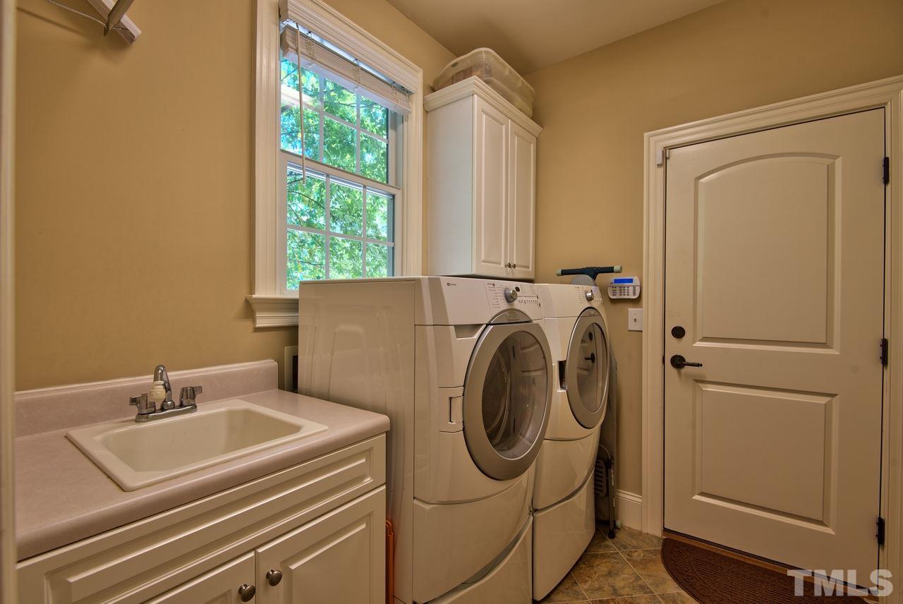 1 Springtree Circle Durham, NC 27712 - Photo 14 of 25 The Laundry Room is conveniently located by the garage and having the sink with cabinet storage is great! The Washer and Dryer convey!