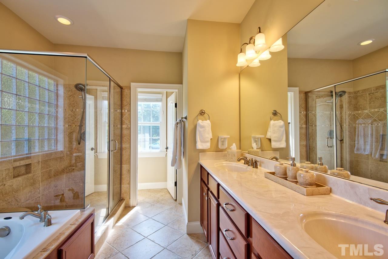 1 Springtree Circle Durham, NC 27712 - Photo 17 of 25 The Master Bath has neutral soothing colors of tile, dual vanities, garden tub and separate shower. The perfect place to escape at the end of the day.