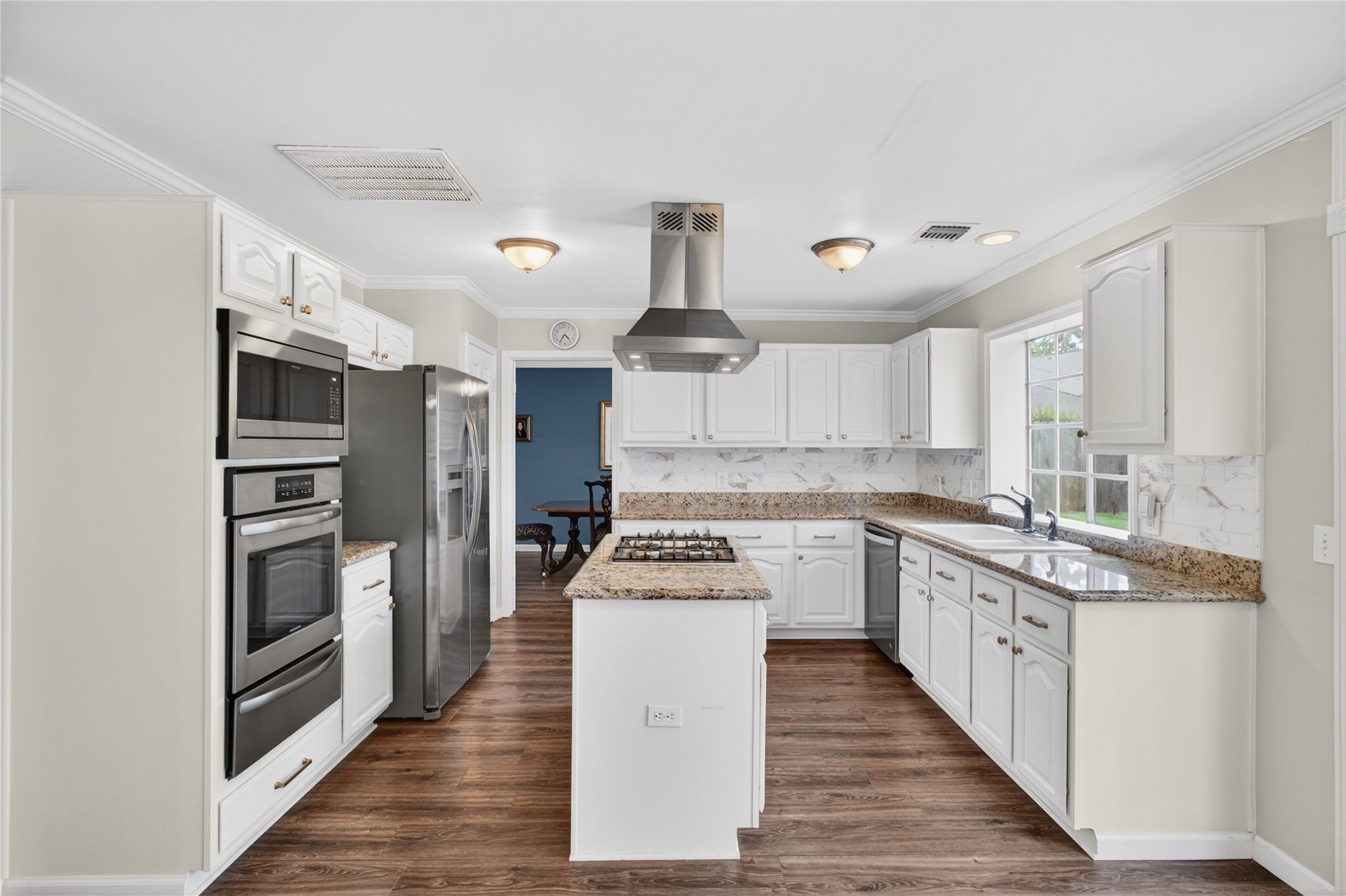 20214 Woodsboro Court Spring, TX 77388 - Photo 12 of 50 Recently Updated Kitchen! Painted cabinets, Stainless Appliances & Vent Hood, Tile Backsplash! Recently Painted Interior! Luxury Vinyl Plank throughout 1st Floor!