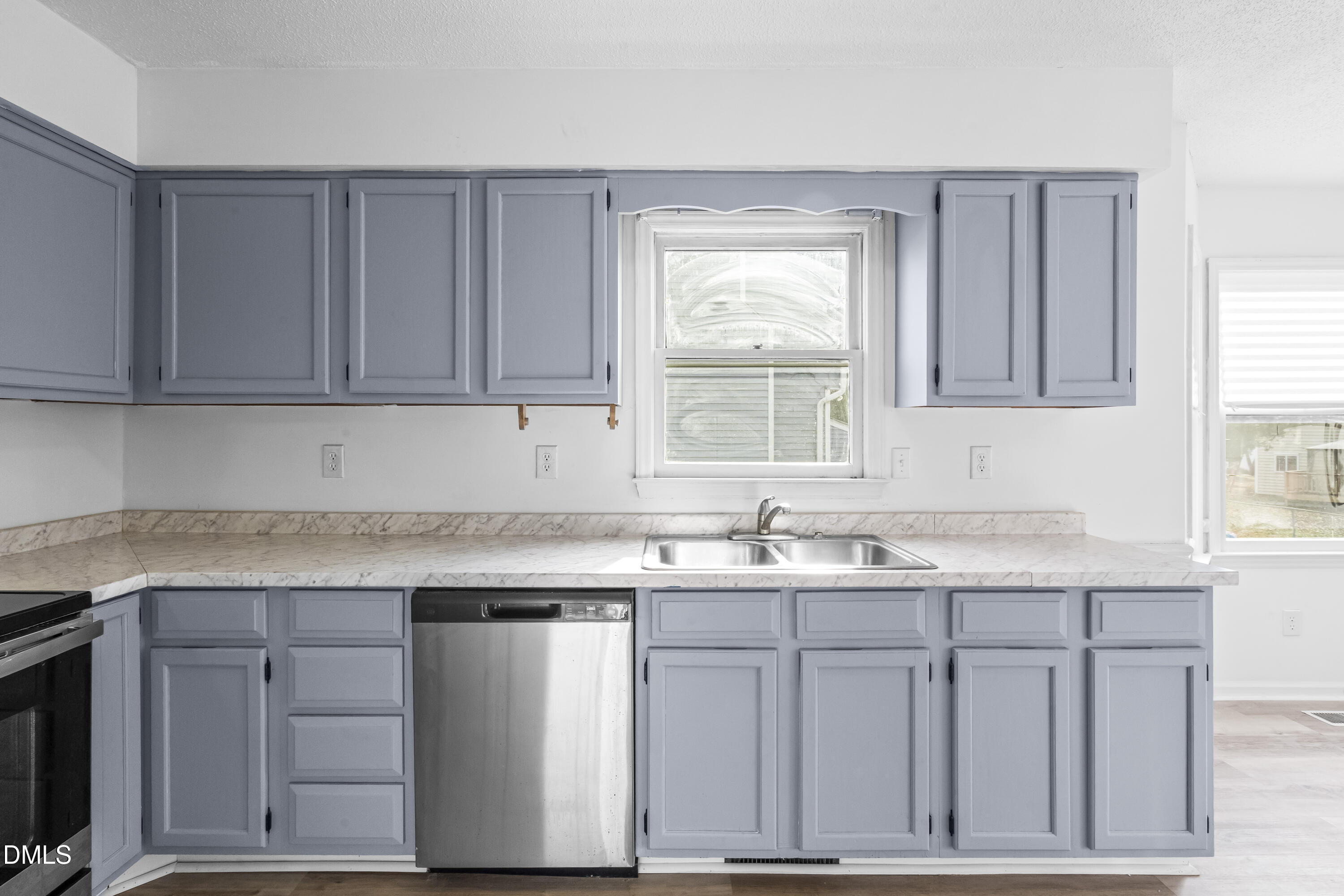 8029 Perry Creek Road Raleigh, NC 27616 - Photo 15 of 27 a kitchen with stainless steel appliances granite countertop a sink dishwasher a stove and a refrigerator