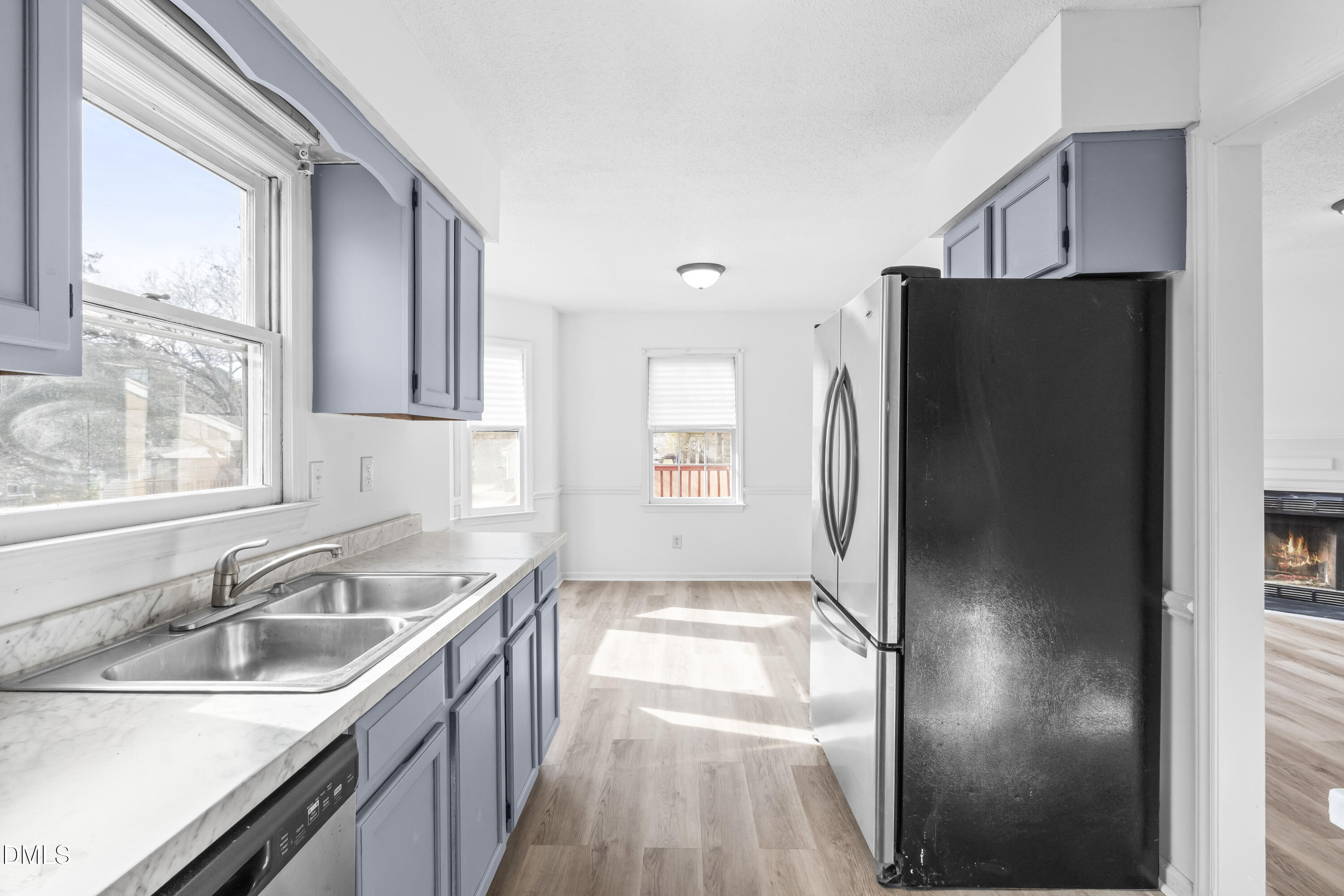 8029 Perry Creek Road Raleigh, NC 27616 - Photo 16 of 27 a kitchen with stainless steel appliances granite countertop a refrigerator and a sink