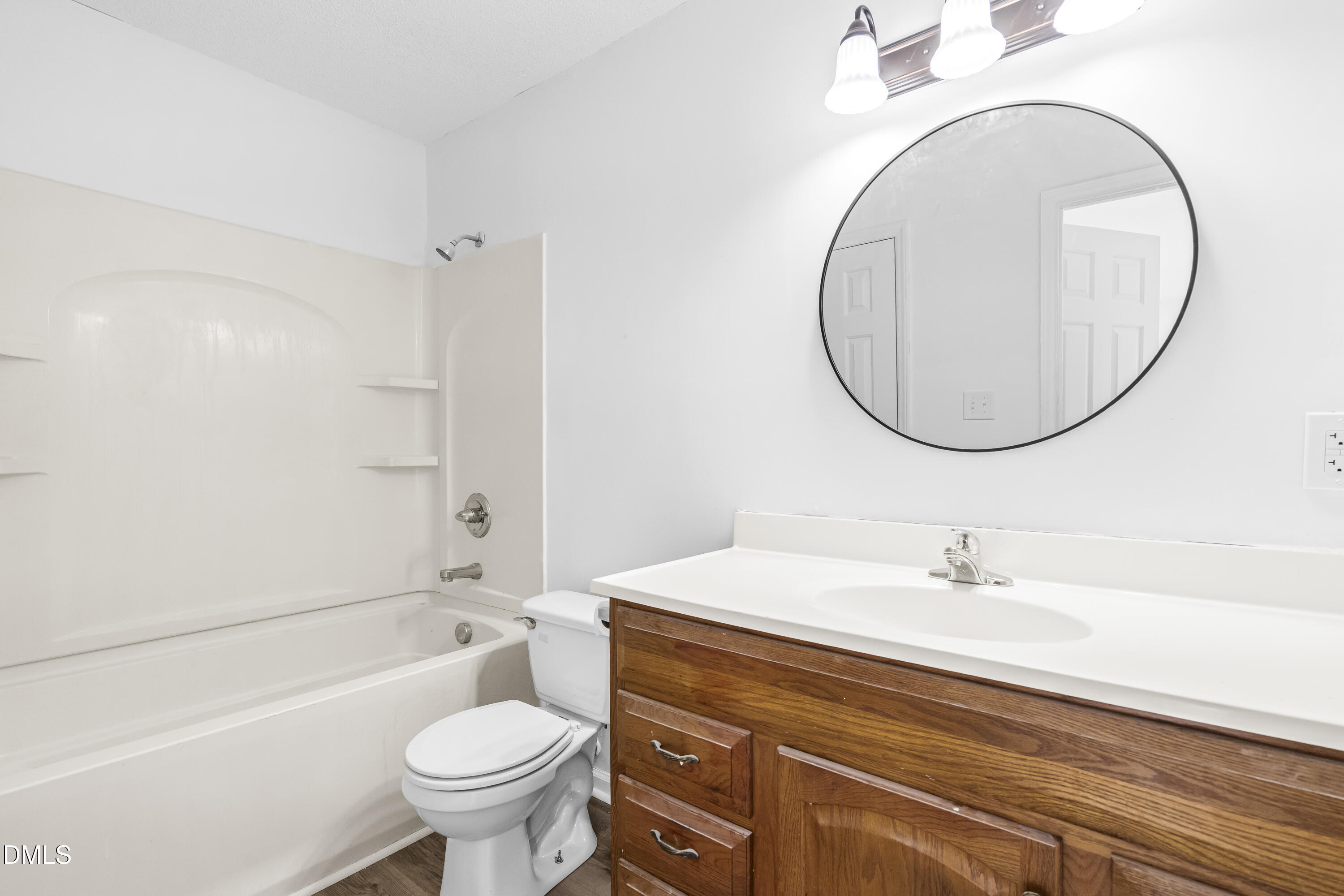 8029 Perry Creek Road Raleigh, NC 27616 - Photo 22 of 27 a bathroom with a sink a toilet and a mirror