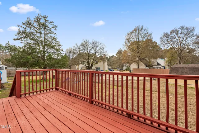 a balcony with wooden floor and fence