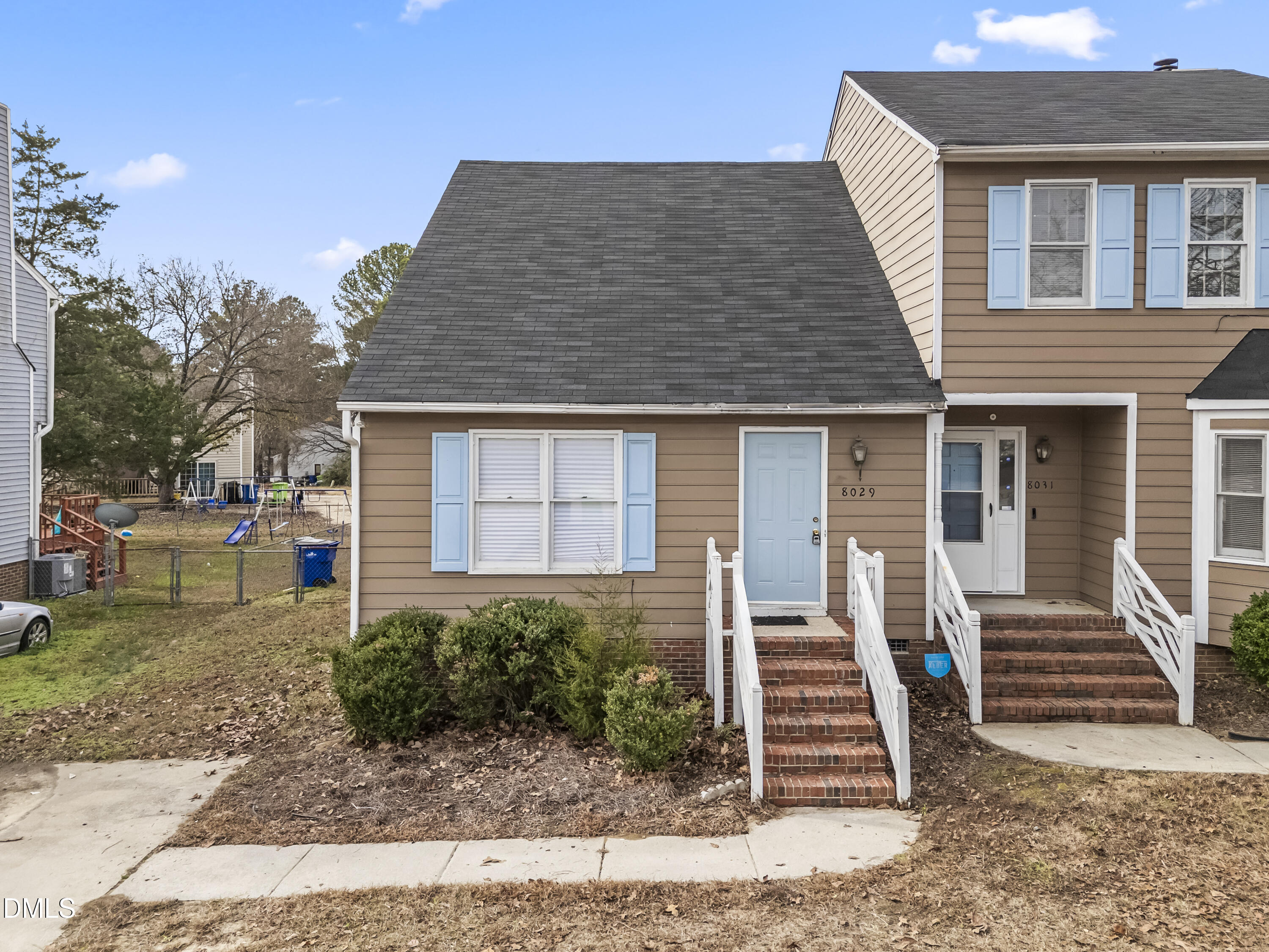 8029 Perry Creek Road Raleigh, NC 27616 - Photo 3 of 27 a front view of a house with a garden