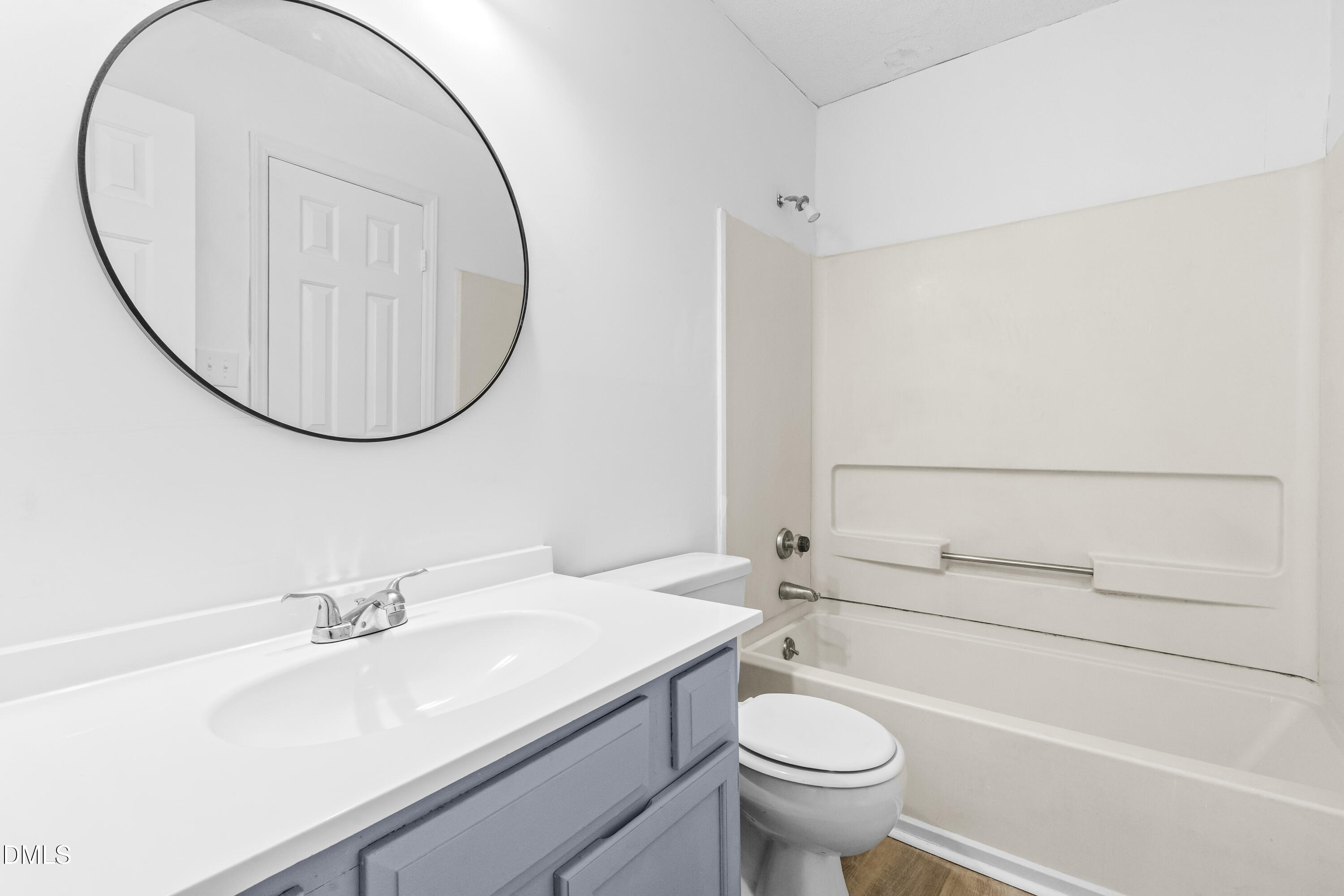8029 Perry Creek Road Raleigh, NC 27616 - Photo 8 of 27 a bathroom with a sink a toilet and a mirror