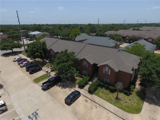 an aerial view of multiple houses with yard